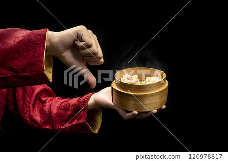 Chinese person showing dim sum dumpling on bamboo wooden basket bowl 120978817
