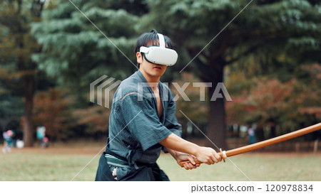 Virtual reality, bamboo sword and Asian man for martial arts, Kendo practice and exercise. Culture, heritage and person with shinai, VR tech and goggles for skills, fight and training in Japan Virtual reality, bamboo sword and Asian man for martial arts, Kendo practice and exercise. Culture, heritage and person with shinai, VR tech and goggles for skills, fight and training in Japan 120978834