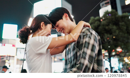 Love, happy couple and hug in city at night for support, loyalty and commitment on vacation. Japanese man, woman and embrace outdoor for romantic relationship, connection and forehead touch on date Love, happy couple and hug in city at night for support, loyalty and commitment on vacation. Japanese man, woman and embrace outdoor for romantic relationship, connection and forehead touch on date 120978845
