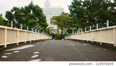 Japanese women, running and race in city of sports exercise, marathon training and workout practice. Athlete, people and cardio fitness with competition, pace performance and wellness on Japan bridge Japanese women, running and race in city of sports exercise, marathon training and workout practice. Athlete, people and cardio fitness with competition, pace performance and wellness on Japan bridge 120978869