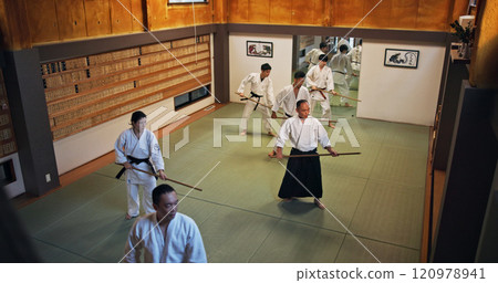 Dojo, group class and Aikido training in gym with wood sword Japanese martial arts and fight exercise in wellness studio. Learning, sport and bamboo weapon with people and strike practice for defence Dojo, group class and Aikido training in gym with wood sword Japanese martial arts and fight exercise in wellness studio. Learning, sport and bamboo weapon with people and strike practice for defence 120978941