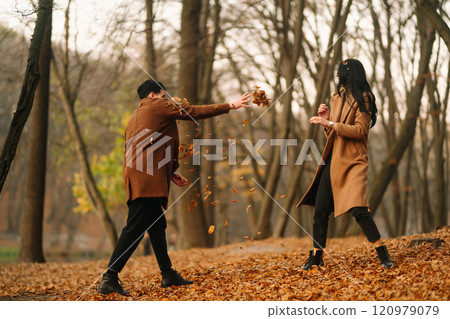 Young couple in love walking in the park on a autumn day. Enjoying time together. 120979079