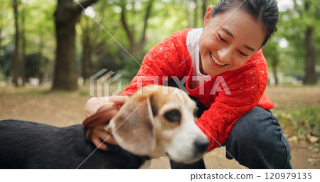 Nature, laugh and woman with dog in forest for bonding, companion and love for adoption. Happy, connection and Japanese female person with beagle puppy for pet outdoor in woods for playing together. 120979135