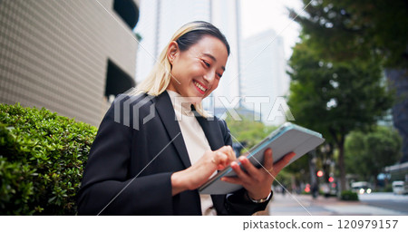 Tablet, city and happy Japanese woman with business commute, morning and tech of lawyer below. Online, digital and booking on transport app for travel to work with website, internet and trip in Tokyo 120979157