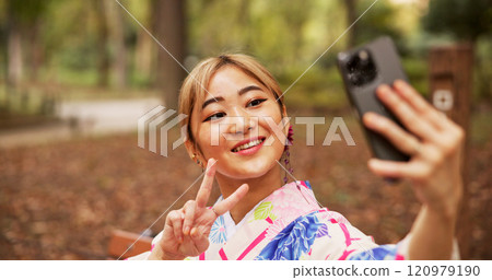Selfie, park and woman in nature, peace sign and happy for memory on vacation, travel and kimono. Outdoor, photography and gesture for profile picture, digital and photo for social media in Japan Selfie, park and woman in nature, peace sign and happy for memory on vacation, travel and kimono. Outdoor, photography and gesture for profile picture, digital and photo for social media in Japan 120979190