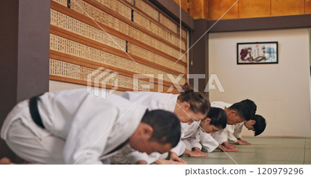 Bow, respect and people in martial arts studio for practice, training or self defense class. Culture, karate and group of students with greeting or etiquette gesture to master in dojo for honor. Bow, respect and people in martial arts studio for practice, training or self defense class. Culture, karate and group of students with greeting or etiquette gesture to master in dojo for honor. 120979296