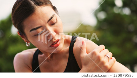 Outdoor, woman and fitness with shoulder pain from exercise strain with muscle ache and injury in Japan. Female person, workout and active with inflammation or sore for self care, health or wellbeing 120979583
