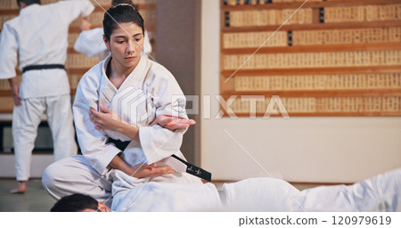 Karate, martial arts and self defense with people in dojo for demonstration, fitness or training. Challenge, grappling or technique with Sensei and student in Japan for combat, fighting or sports 120979619