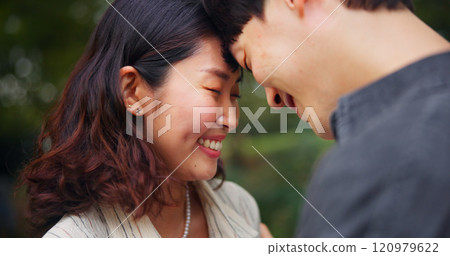 Happy couple, love and forehead touch outdoor in commitment, loyalty or support together. Japanese man, woman and romantic relationship on date at park for connection, care or trust on valentines day 120979622
