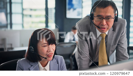 Business, employees and computer as call center agents on training for customer service, help or support in Japan. People, mature woman and man at office with teaching or assistance for telemarketing 120979647