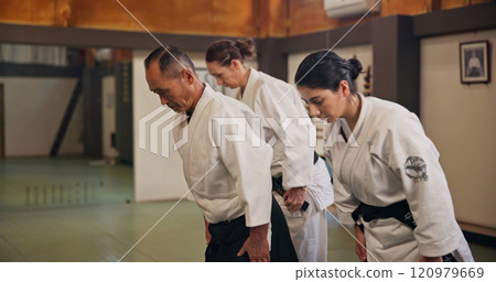 Bow, greeting and students in martial arts studio for practice, training or self defense class. Culture, karate and group of people with respect or etiquette gesture to master in dojo for honor. 120979669