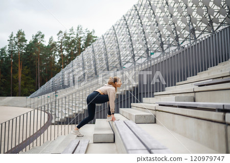 Active lifestyle. Young fitness woman exercising and stretching outdoors. Sports, sports training. Active lifestyle. Young fitness woman exercising and stretching outdoors. Sports, sports training. 120979747