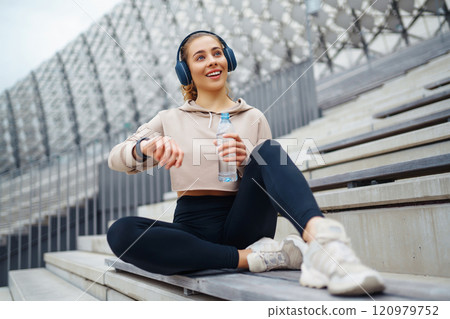 Active lifestyle. Young fitness woman exercising and stretching outdoors. Sports, sports training. 120979752