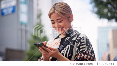 Japanese, woman and city with phone for social media, online communication and search location. Outdoor, female person and smile with mobile application for chat, travel and map navigation in Tokyo 120979834