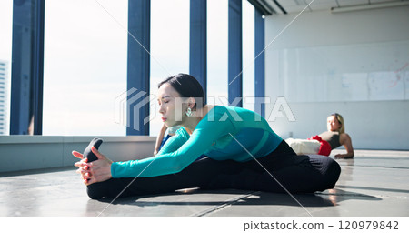 Dancer, fitness and stretching legs for body health, start or prepare for performance in studio. Warm up, flexibility and Japanese woman exercise back, hamstring muscle and practice on floor in class 120979842