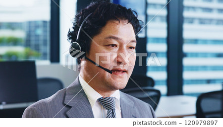 Call center, headset and Japanese man in agency for customer service, technical support or consulting. Male person, microphone and telecommunication for advice, conversation and feedback as help desk 120979897