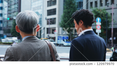 Men, business people and walking in city for travel, commute and location journey to workplace. Colleagues, employees and lawyers by sidewalk for corporate career, urban trip or professional in Japan 120979970