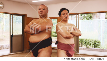 Sumo wrestler, arms crossed and portrait of Japanese people in dojo ring for pride, training or martial arts fight. Tournament, challenge and battle with men for festival, competition and culture 120980021
