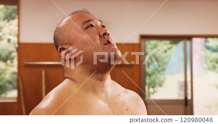 Athlete, man and exercise for sumo, training and fatigue with exhausted, breathing and break in Japan. Fitness, tired and sports in dohyo for practice, workout and wrestling with bruise or recovery 120980048
