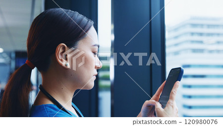 Medical student, mobile phone and typing in hospital for communication or networking in Japan. Female person, technology and texting for post, update or chat with serious, concentration or confidence 120980076