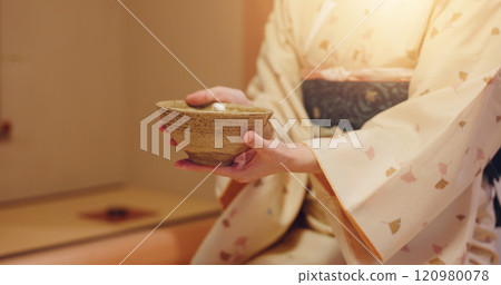 Hands, hostess and woman with bowl, chawan and traditional kimono for tea ceremony. Japanese ritual, spirituality and mindfulness with cultural outfit for matcha drink, respect and home hospitality 120980078