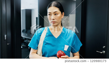 Thinking, nurse and Asian woman with apple in office for nutrition, healthcare or healthy food choice. Morning, breakfast ideas or surgeon in wellness clinic with fruit, fibre and vitamin c in Japan Thinking, nurse and Asian woman with apple in office for nutrition, healthcare or healthy food choice. Morning, breakfast ideas or surgeon in wellness clinic with fruit, fibre and vitamin c in Japan 120980173