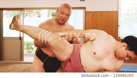 Men, fitness and exercise for sumo, sports and stretching with preparation, balance and legs in Japan. Japanese athlete, fighter and practice in dohyo for training, workout and wrestling with warm up 120980205