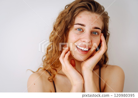 Close-up of a cute woman with problem skin looking in the mirror. Dermatology concept, allergy. Close-up of a cute woman with problem skin looking in the mirror. Dermatology concept, allergy. 120980395