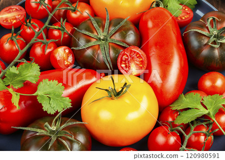 Fresh tomatoes on a plate. 120980591