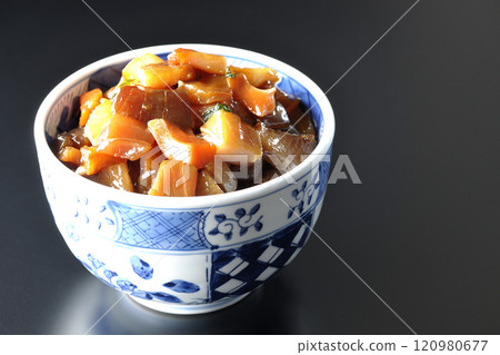A luxurious, heaping bowl of pickled seafood photographed against a black background 120980677