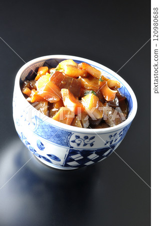 A luxurious, heaping bowl of pickled seafood photographed against a black background 120980688