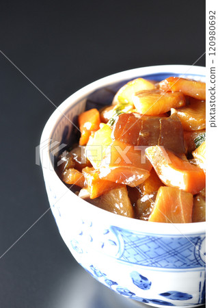 A luxurious, heaping bowl of pickled seafood photographed against a black background 120980692