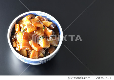 A luxurious, heaping bowl of pickled seafood photographed against a black background 120980695