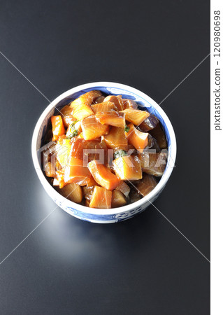 A luxurious, heaping bowl of pickled seafood photographed against a black background 120980698