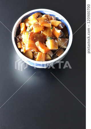 A luxurious, heaping bowl of pickled seafood photographed against a black background 120980700