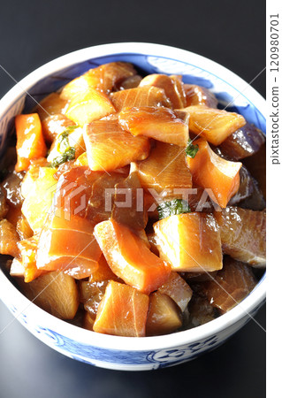 A luxurious, heaping bowl of pickled seafood photographed against a black background 120980701