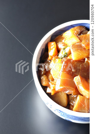 A luxurious, heaping bowl of pickled seafood photographed against a black background 120980704