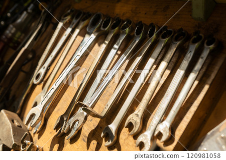 Wooden rack with tools for car repair in an auto repair shop or garage Wooden rack with tools for car repair in an auto repair shop or garage 120981058
