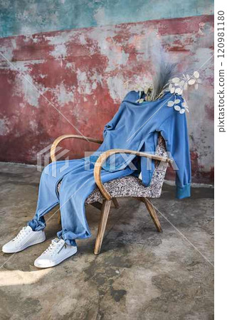 Blue Jumpsuit Draped on Vintage Armchair Blue Jumpsuit Draped on Vintage Armchair 120981180
