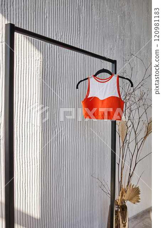 Orange and White Sports Bra on Minimalist Rack 120981183