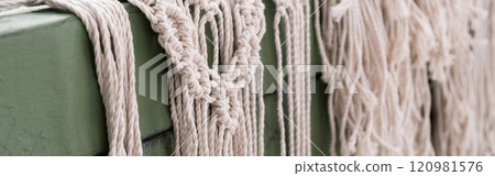 Woman weaves home Handmade decor from cotton thread macrame. Macrame panel creating process. Banner Woman weaves home Handmade decor from cotton thread macrame. Macrame panel creating process. Banner 120981576