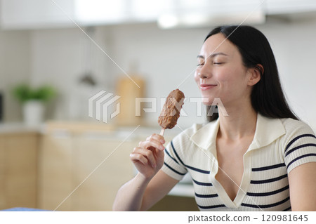 Asian woman smelling chocolate ice cream 120981645