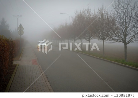Bad weather driving - foggy hazy country road. Motorway - road traffic. Winter time. 120981975