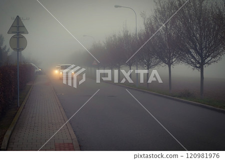 Bad weather driving - foggy hazy country road. Motorway - road traffic. Winter time. 120981976