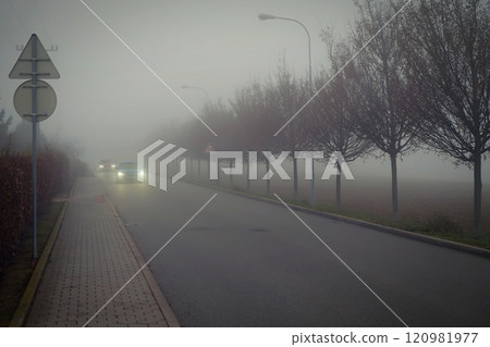 Bad weather driving - foggy hazy country road. Motorway - road traffic. Winter time. 120981977