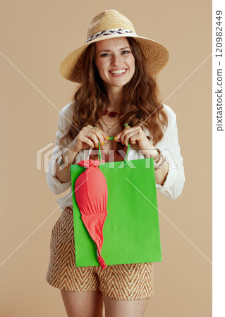 happy stylish woman in blouse and shorts isolated on beige happy stylish woman in blouse and shorts isolated on beige 120982449