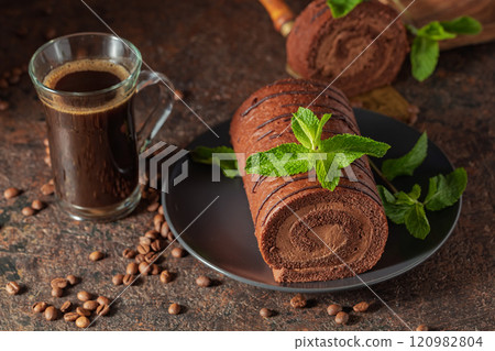 Homemade chocolate cake and a mug of black coffee. Homemade chocolate cake and a mug of black coffee. 120982804