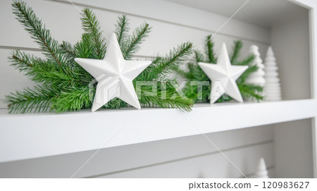 Elegant Home Christmas Decor, White Ceramic Stars and Green Pine Branches on a Shelf 120983627