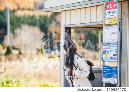 A young woman waiting for a bus at a bus stop. Photo courtesy of Ugo Kotsu. A young woman waiting for a bus at a bus stop. Photo courtesy of Ugo Kotsu. 120984078