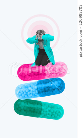 Contemporary art collage. Distressed doctor in medical attire kneels on stack of oversized capsules, highlighting emotional weight of healthcare challenges. 120985705